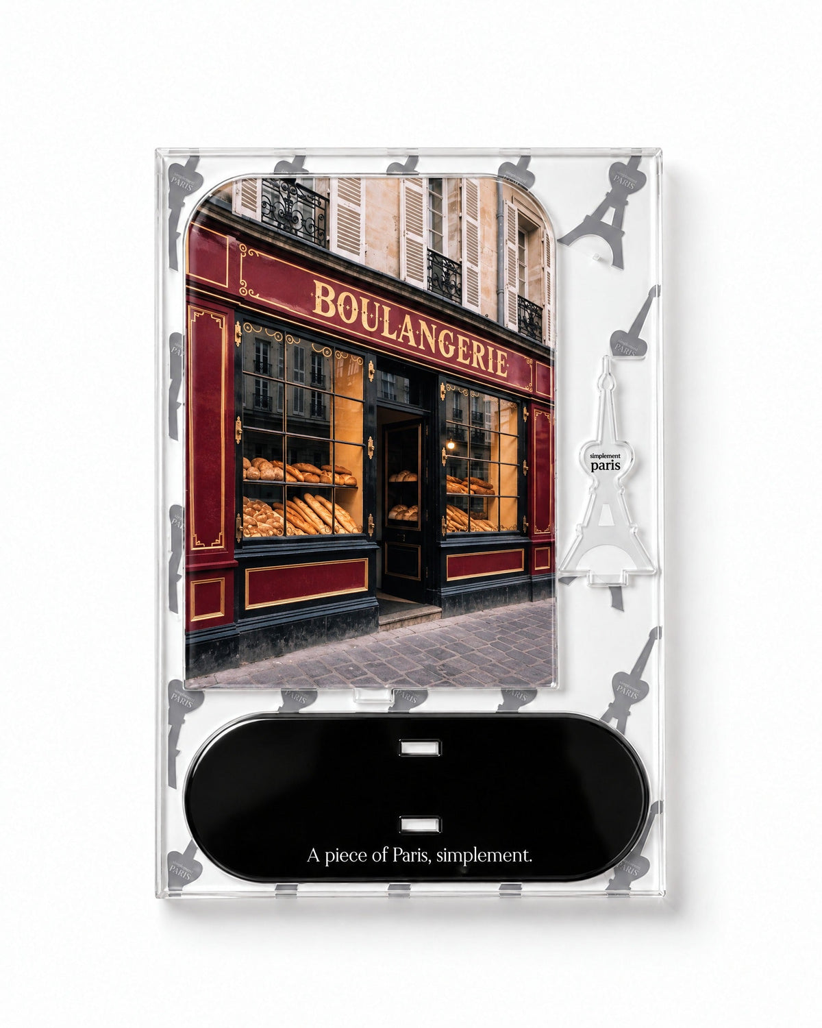 Flat-pack contents of La Boulangerie: acrylic panel, glossy black base and Eiffel Tower piece