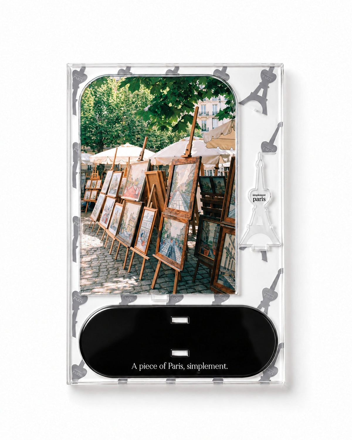 Flat-pack contents of Les Artistes: acrylic panel, glossy black base and Eiffel Tower piece