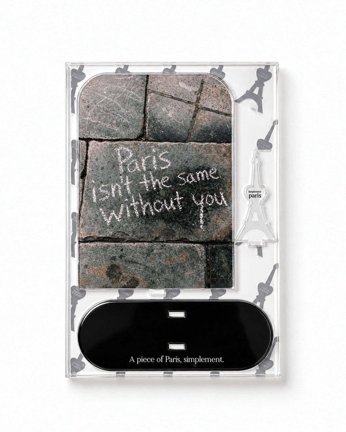 Flat-pack contents of Paris Without You: printed acrylic panel, glossy black base and Eiffel Tower piece