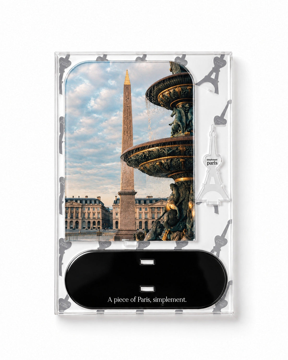 Flat-pack contents of Place de la Concorde: acrylic panel, glossy black base and Eiffel Tower piece