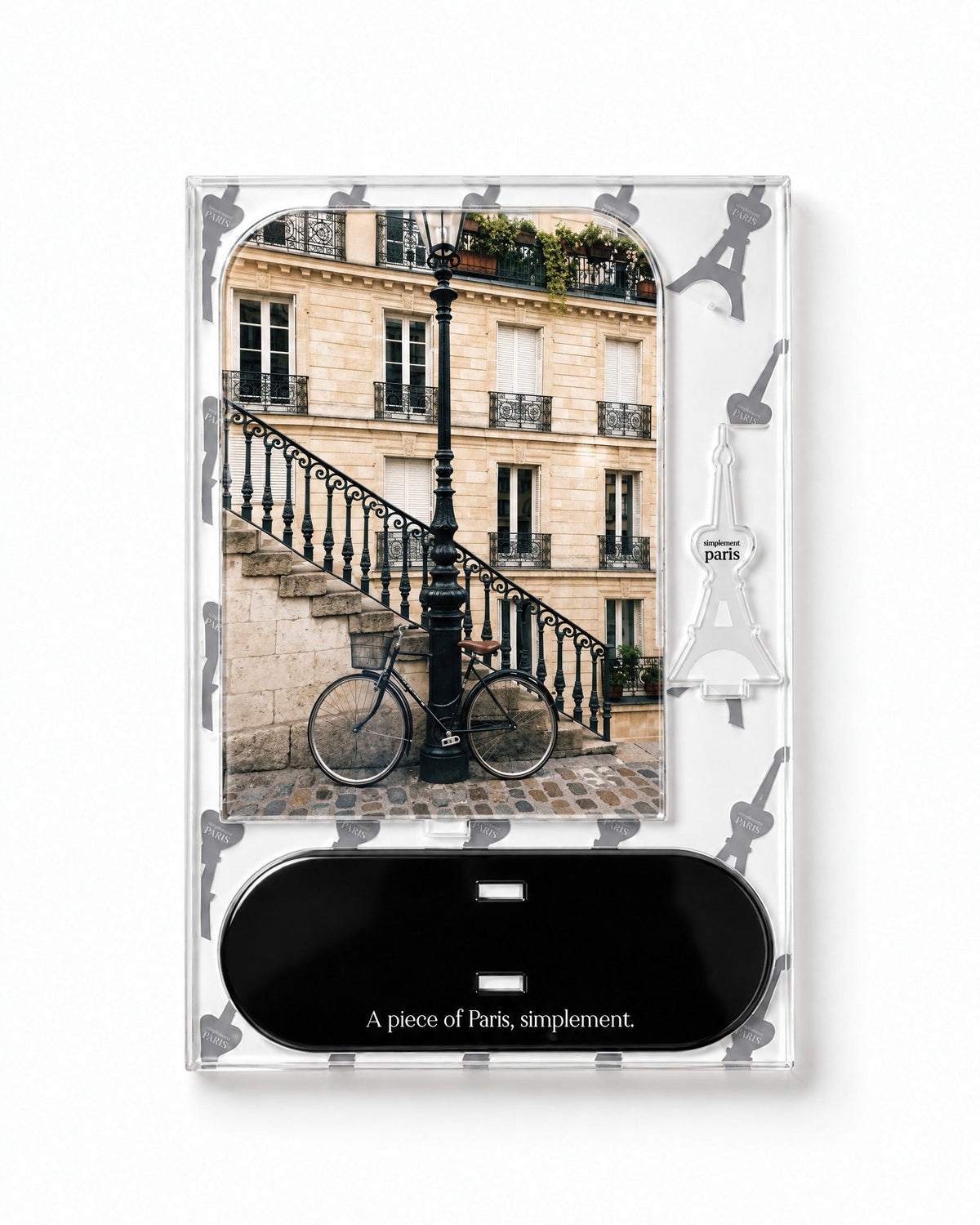 Flat-pack contents of The Parisian Bicycle: acrylic panel, glossy black base and Eiffel Tower piece